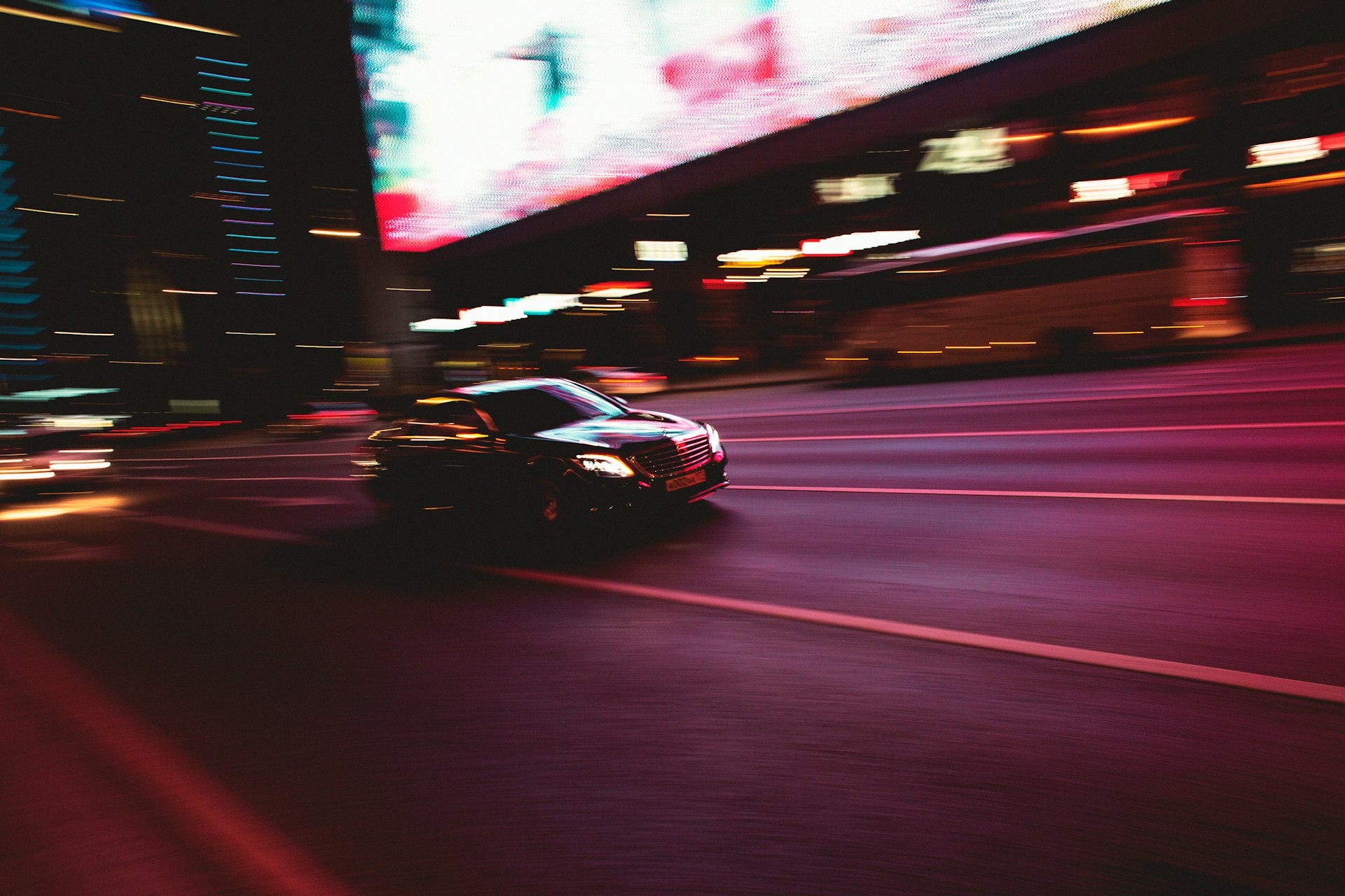 black sedan on road during night time